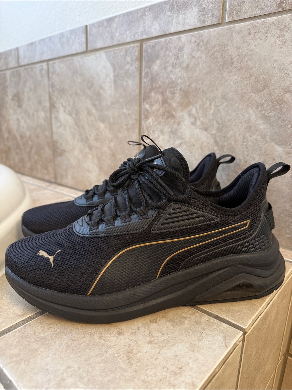 Puma Women’s Black Sneakers with Gold Trim